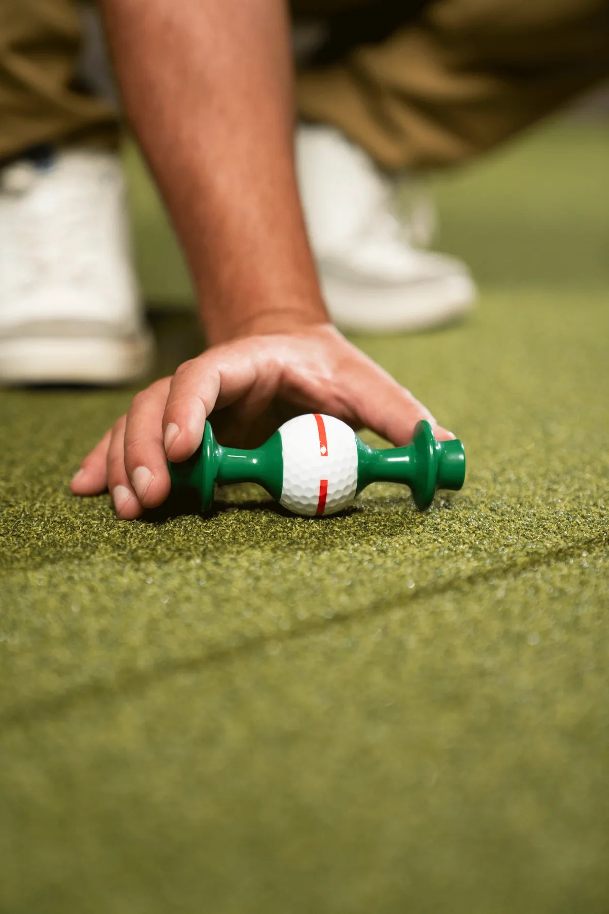 Hand setting the Line Lion down on a putting mat